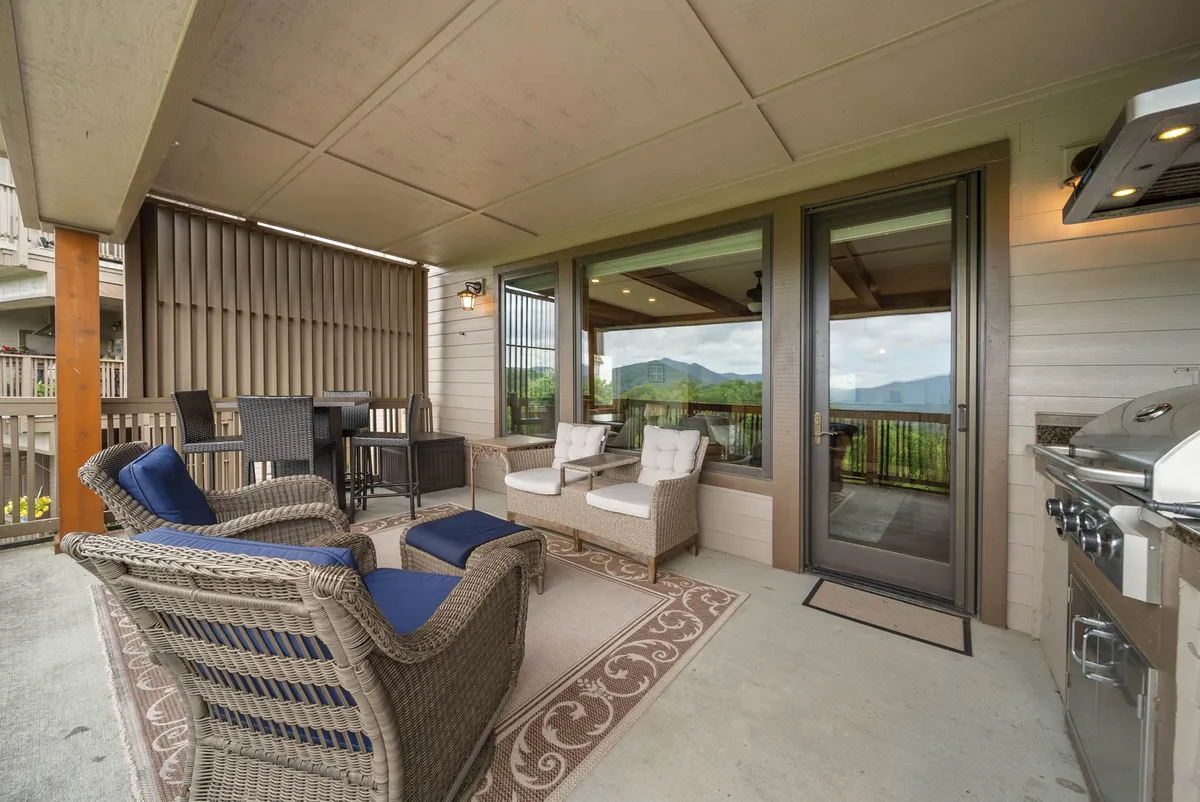 An outdoor deck featuring comfortable seating, a grill station, and stunning mountain views in the background—ideal for al fresco dining or sipping morning coffee while watching the sunrise.